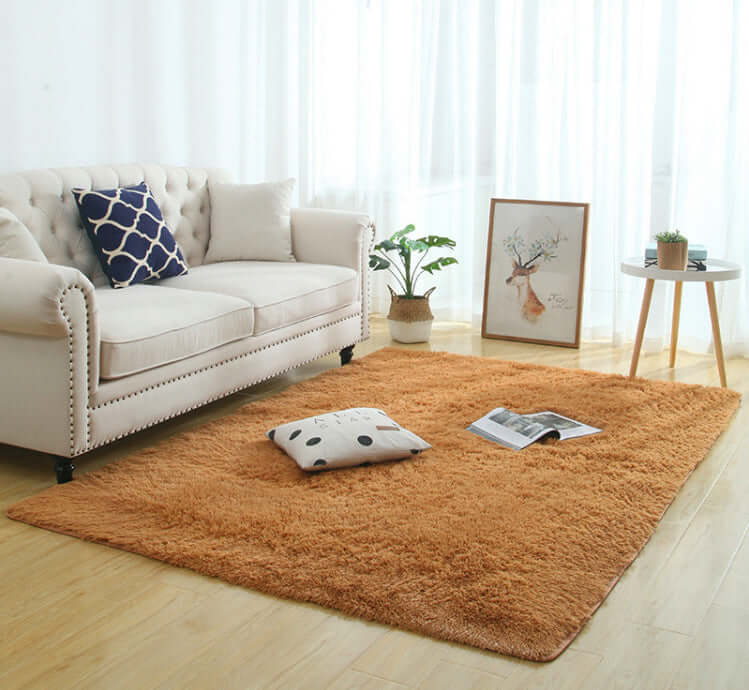 Silky fluffy carpet rug in a cozy living room setting with a beige couch, decorative pillows, and a small table.