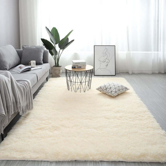 Nordic fluffy carpet rug in a modern living room setting with a sofa, table, and decor. Hand washable, rectangle, plain pattern.