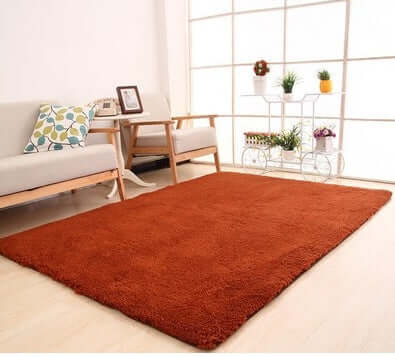Solid rectangular living room rug in rich orange, perfect for home decor and comfortable underfoot.