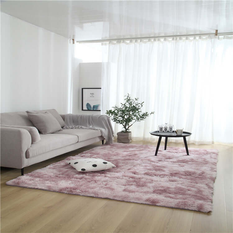 Cozy living room with a pink fuzzy rug, sofa, coffee table, and greenery, showcasing a stylish home decor.