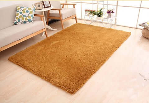 Solid orange living room rug with a plush texture, ideal for home decor and comfort.