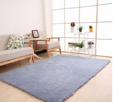 Solid blue living room rug on wooden floor, perfect for European and American style home decor.