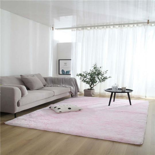 Living room featuring a pink solid color rug, modern sofa, and stylish coffee table, showcasing a cozy decor.