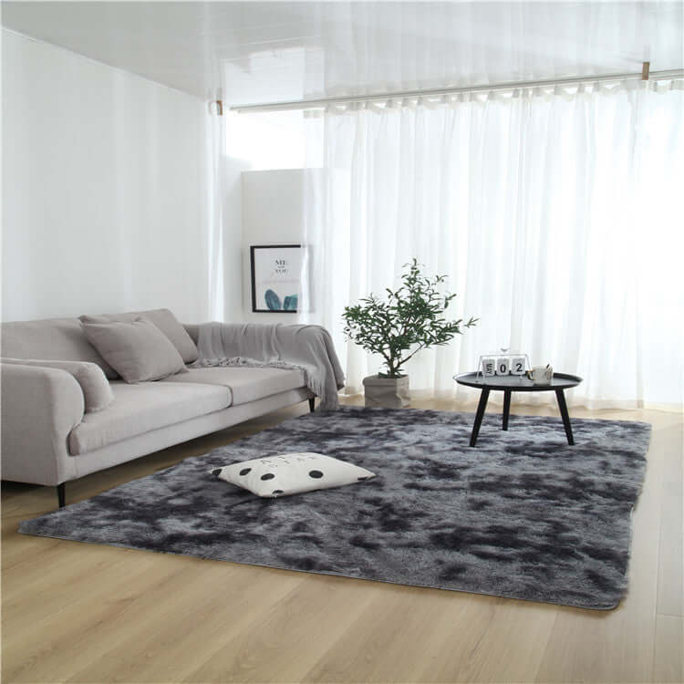 Cozy living room featuring a stylish gray carpet, plush sofa, and modern decor in a bright, airy space.