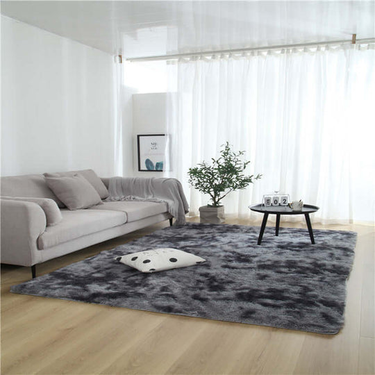 Cozy living room featuring a stylish gray carpet, plush sofa, and modern decor in a bright, airy space.